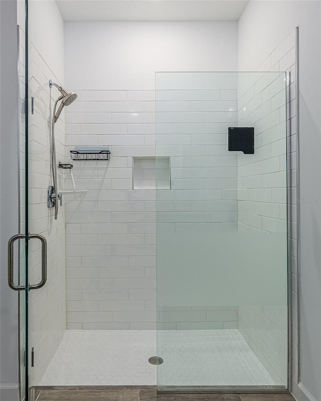 bathroom featuring a shower with shower door