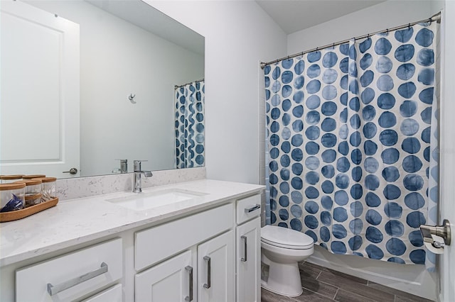 full bathroom with shower / bathtub combination with curtain, vanity, and toilet