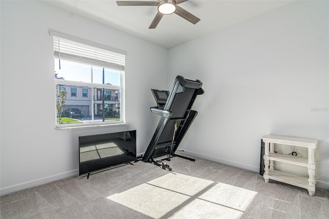 exercise area featuring light colored carpet and ceiling fan