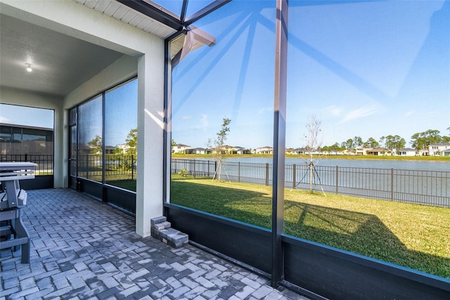 unfurnished sunroom with a water view