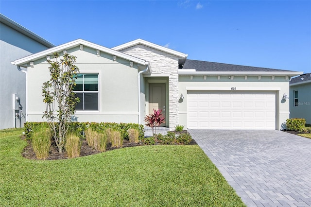 view of front of property featuring a garage and a front lawn