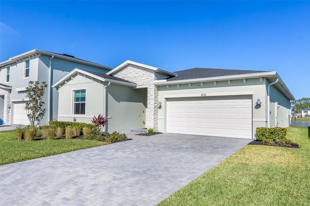 view of front of house featuring a garage and a front lawn