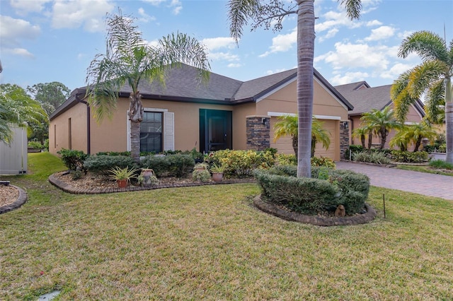 ranch-style home featuring a garage and a front yard