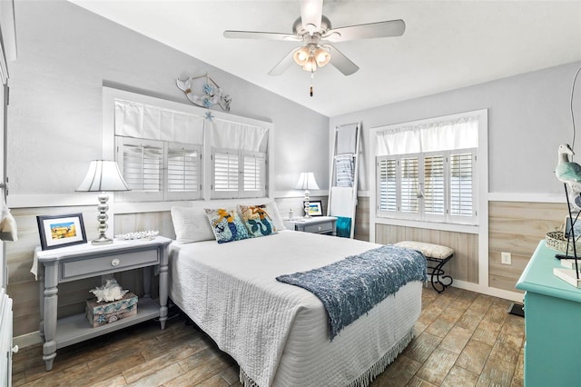 bedroom featuring ceiling fan, lofted ceiling, and dark wood-type flooring