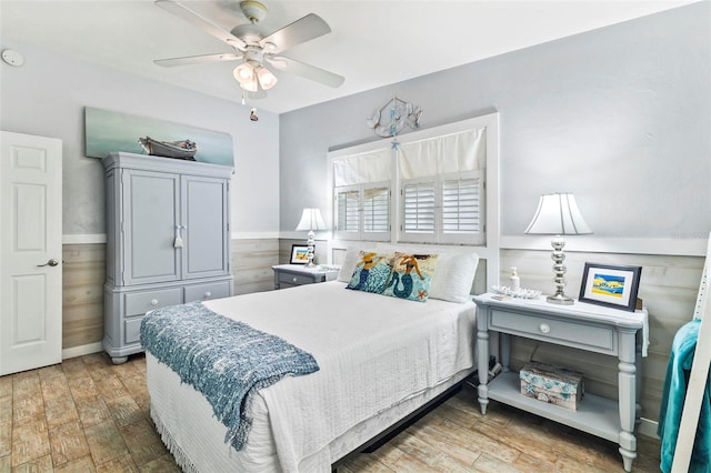 bedroom with light hardwood / wood-style floors and ceiling fan