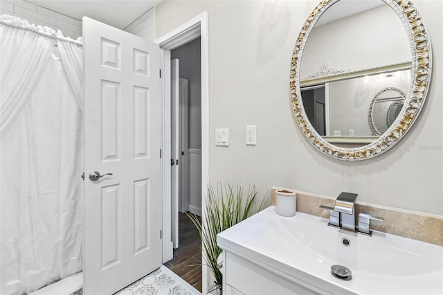 bathroom with a shower with shower curtain, vanity, and hardwood / wood-style flooring