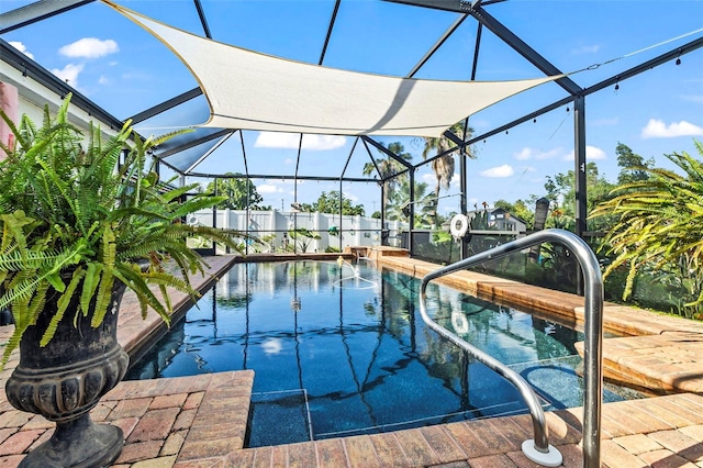 view of pool with glass enclosure