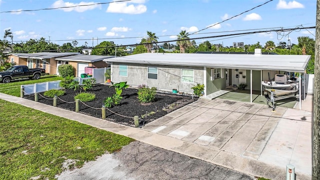 view of front of property with a front lawn and a carport