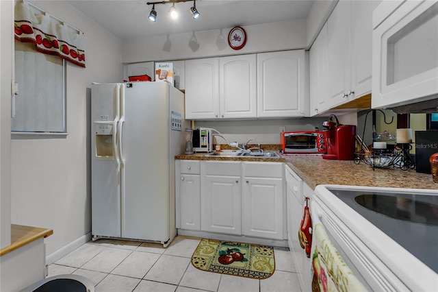 2868 N Powers Dr Unit 5, Orlando, FL 32818 - kitchen with white appliances, light tile patterned floors, light countertops, white cabinetry, and a sink