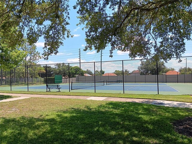 2868 N Powers Dr Unit 5, Orlando, FL 32818 - view of sport court with fence and a lawn