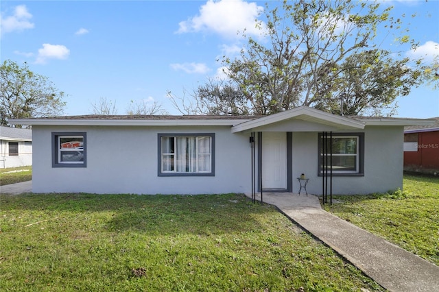 ranch-style house with a front lawn