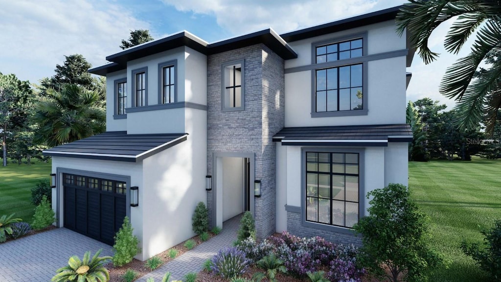 view of front of property featuring a garage and a front lawn