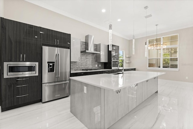 kitchen featuring marble finish floor, appliances with stainless steel finishes, modern cabinets, and wall chimney exhaust hood