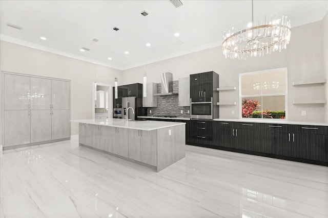 kitchen with wall chimney range hood, oven, open shelves, a notable chandelier, and decorative backsplash