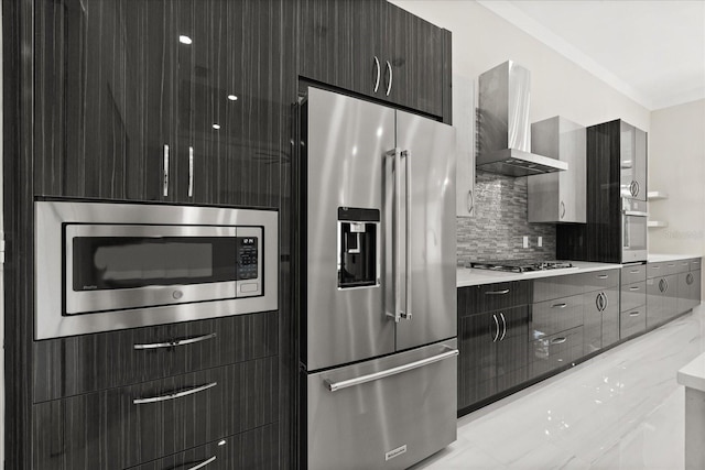 kitchen featuring appliances with stainless steel finishes, modern cabinets, and wall chimney range hood