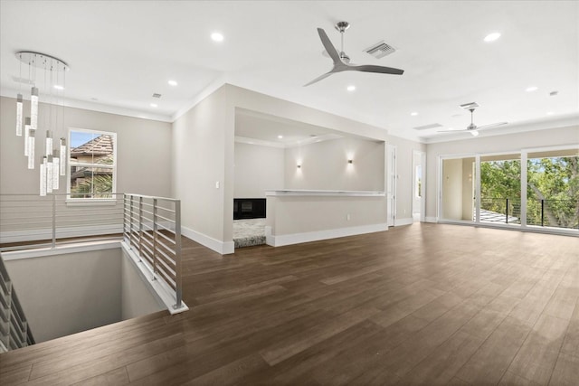 unfurnished living room with a ceiling fan, wood finished floors, baseboards, ornamental molding, and recessed lighting