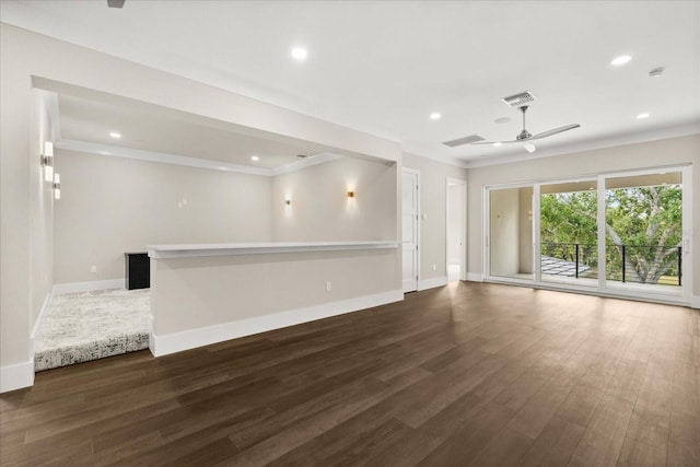 unfurnished living room with crown molding, baseboards, and wood finished floors