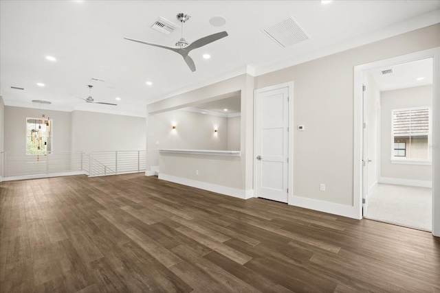 unfurnished living room with dark wood-style flooring, a ceiling fan, and visible vents