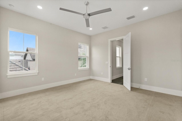 unfurnished room featuring visible vents, baseboards, recessed lighting, a ceiling fan, and carpet