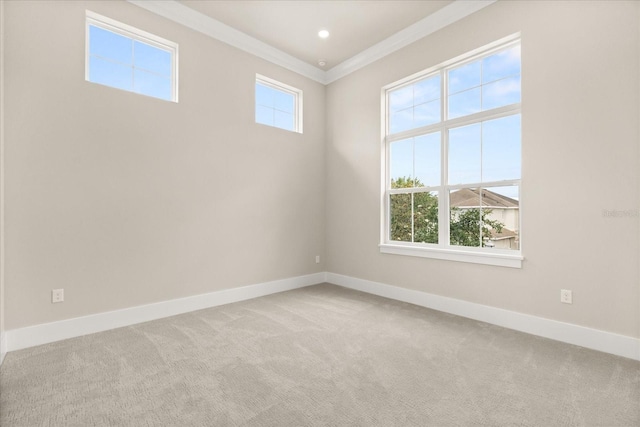 unfurnished room featuring carpet floors, baseboards, and ornamental molding