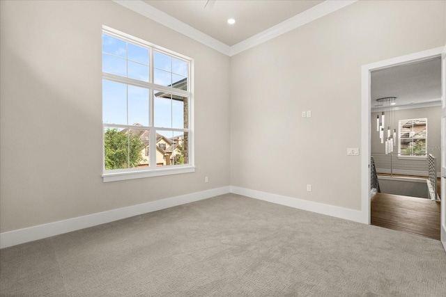 carpeted spare room featuring crown molding, recessed lighting, baseboards, and plenty of natural light