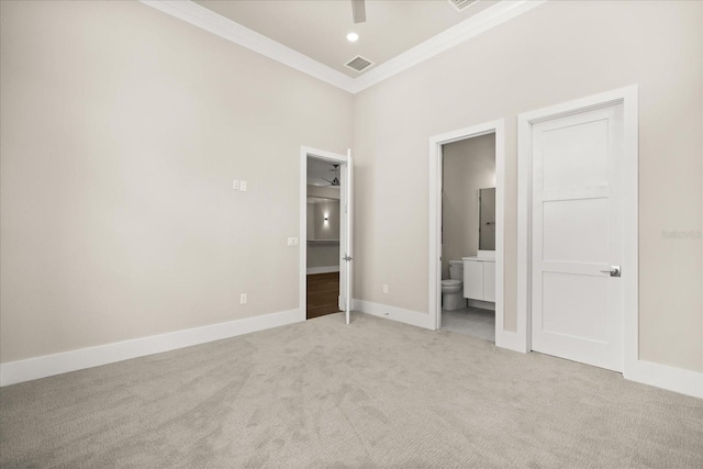 unfurnished bedroom with light colored carpet, baseboards, ensuite bathroom, visible vents, and ornamental molding