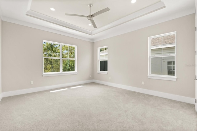 unfurnished room with a raised ceiling, a ceiling fan, recessed lighting, and carpet floors