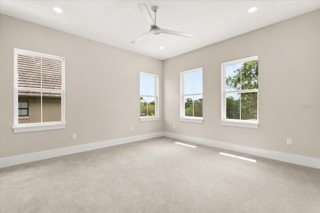 unfurnished room with baseboards, a ceiling fan, and a healthy amount of sunlight