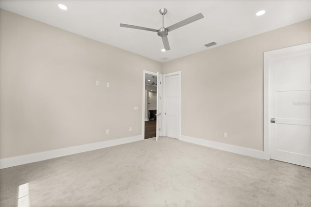 unfurnished bedroom with ceiling fan, visible vents, light colored carpet, baseboards, and recessed lighting