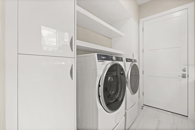 laundry room with separate washer and dryer, laundry area, and marble finish floor
