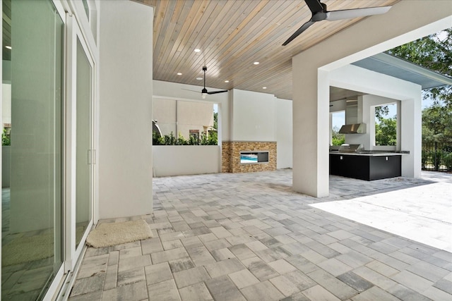 view of patio featuring an outdoor kitchen and ceiling fan