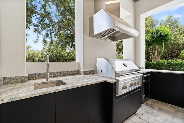 view of patio / terrace with exterior kitchen, a sink, and grilling area