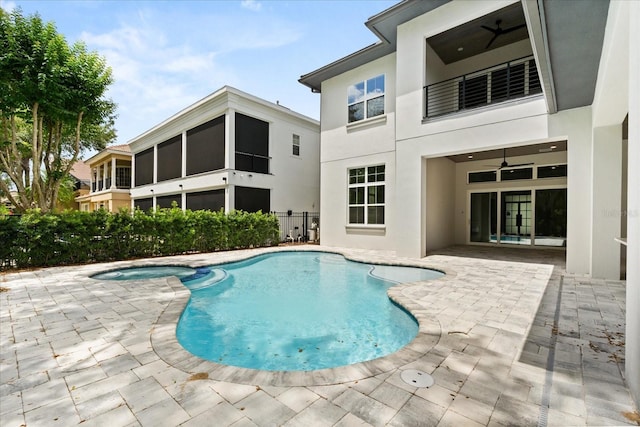 view of swimming pool featuring a ceiling fan, a patio area, and a pool with connected hot tub