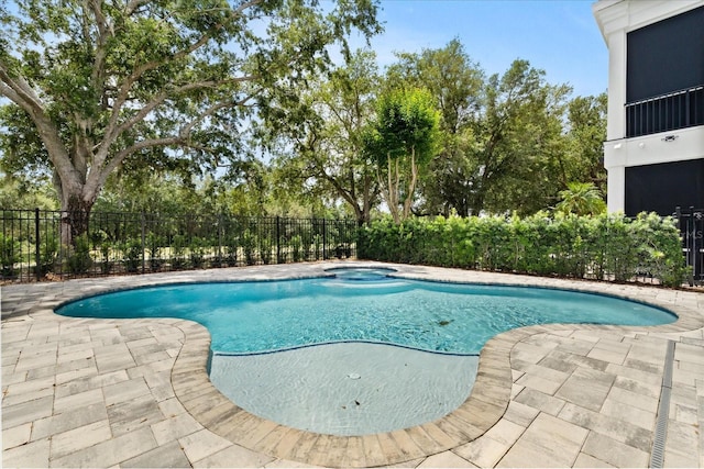 view of swimming pool with a hot tub, a patio, fence, and a fenced in pool