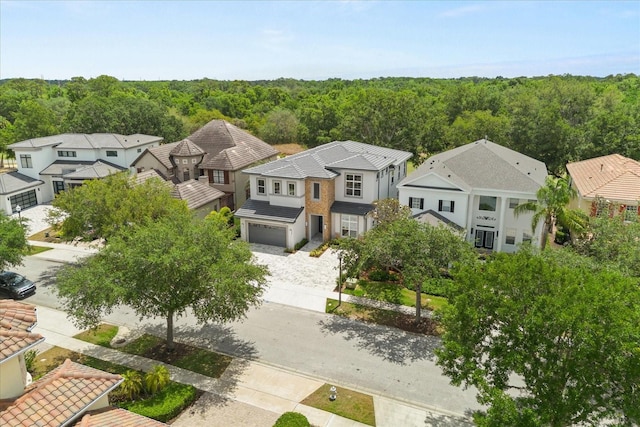 aerial view featuring a residential view and a wooded view
