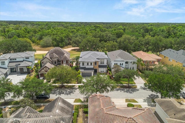aerial view with a wooded view and a residential view