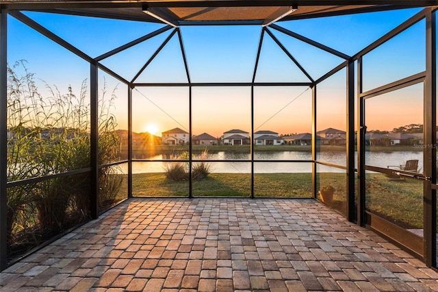 unfurnished sunroom featuring a water view