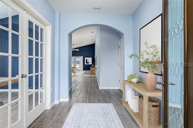 hall featuring french doors and vaulted ceiling