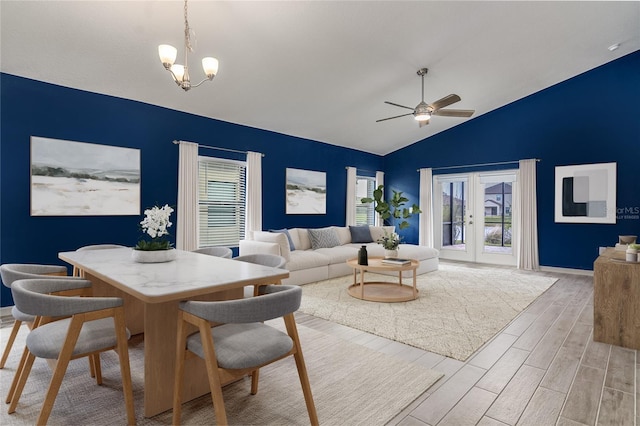 interior space featuring lofted ceiling, ceiling fan with notable chandelier, and light hardwood / wood-style flooring