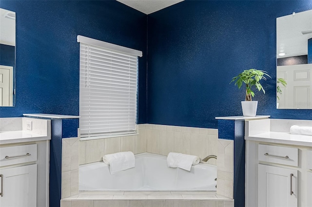 bathroom with a relaxing tiled tub and vanity