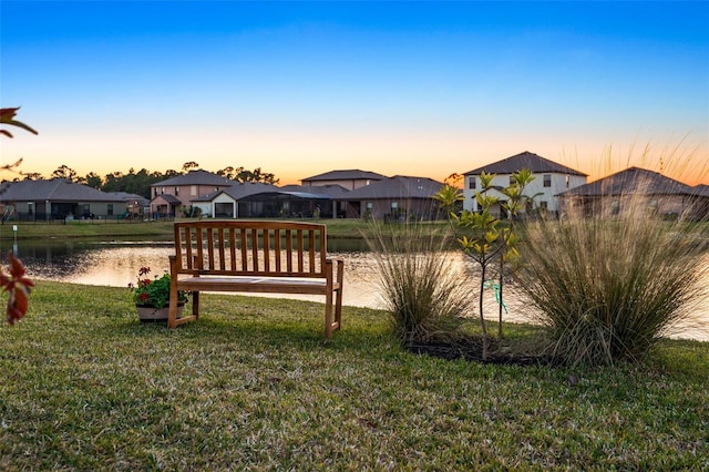 yard at dusk with a water view