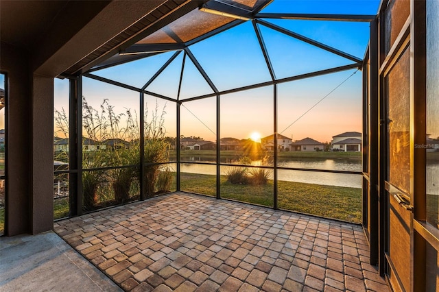 unfurnished sunroom with a water view