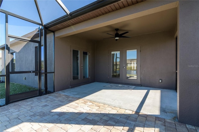 view of patio featuring french doors, ceiling fan, and a lanai