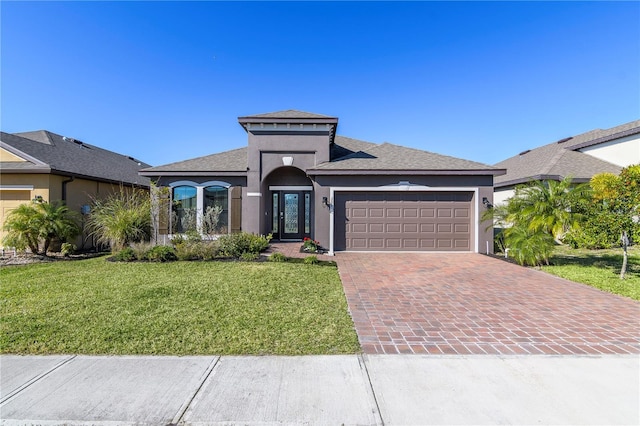 view of front of home featuring a garage and a front lawn