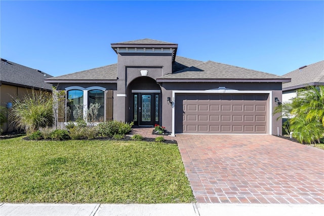 view of front of house featuring a garage and a front yard