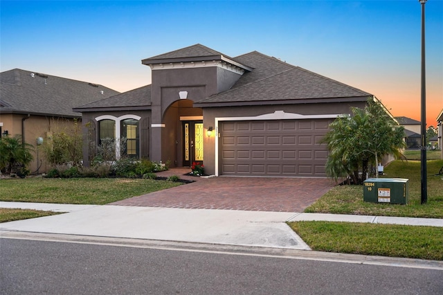 view of front of house with a yard and a garage