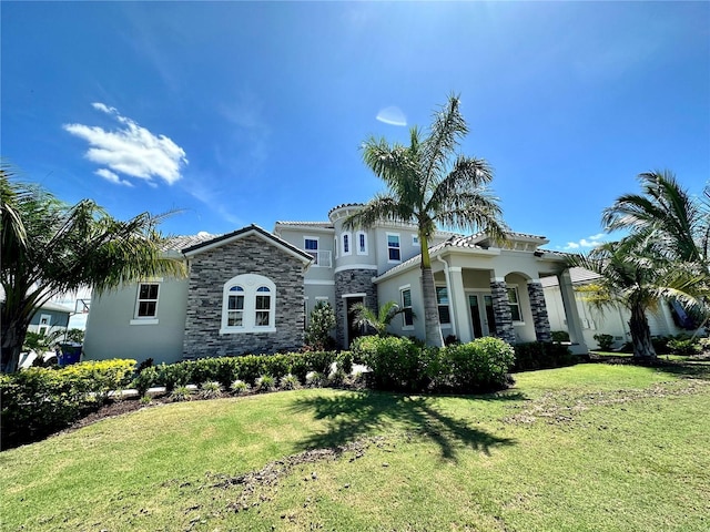 mediterranean / spanish-style house with a front yard