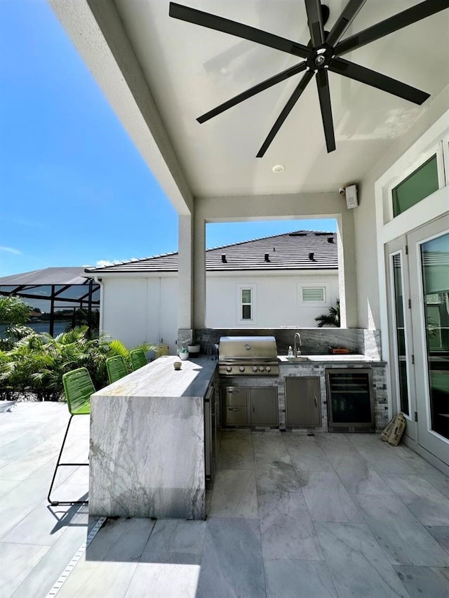 view of patio / terrace featuring area for grilling, ceiling fan, glass enclosure, grilling area, and wine cooler