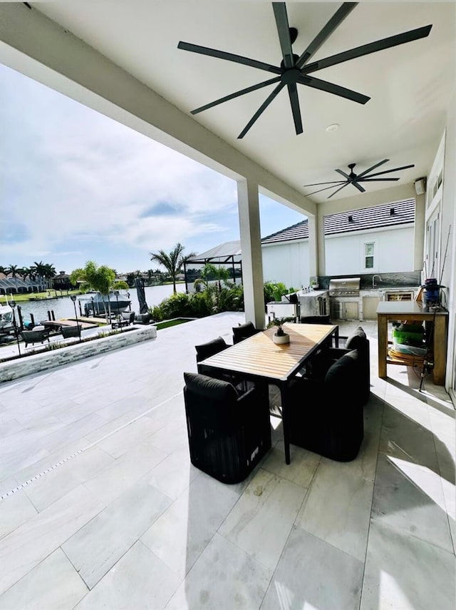 view of patio featuring area for grilling, a water view, and sink