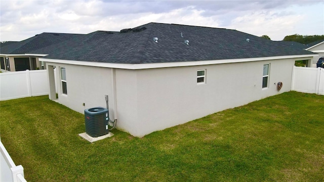 view of side of home with a yard and cooling unit